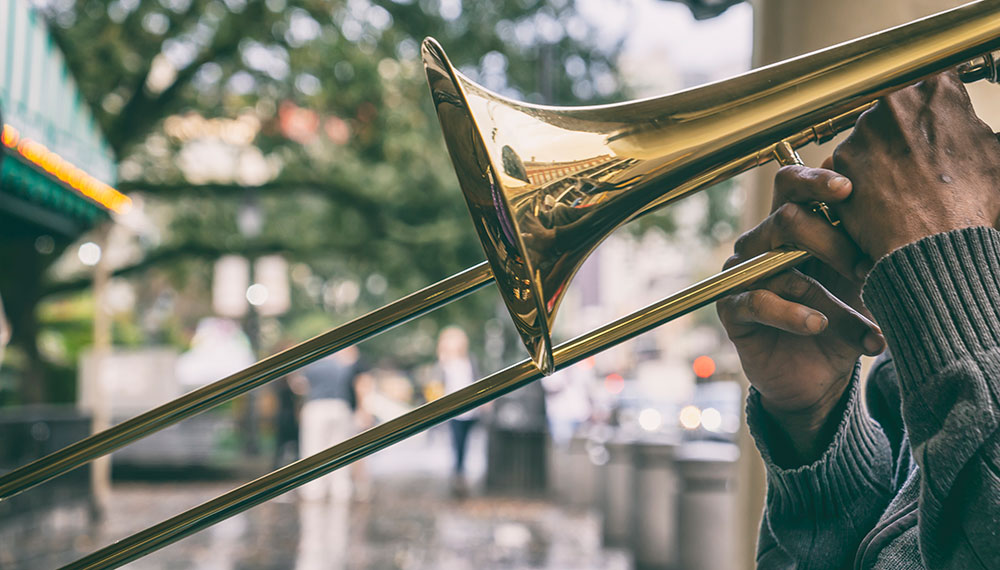 close up of a trombone and a man's hands