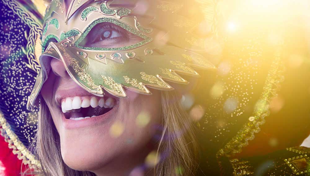Woman attending Mardi Gras in a mask